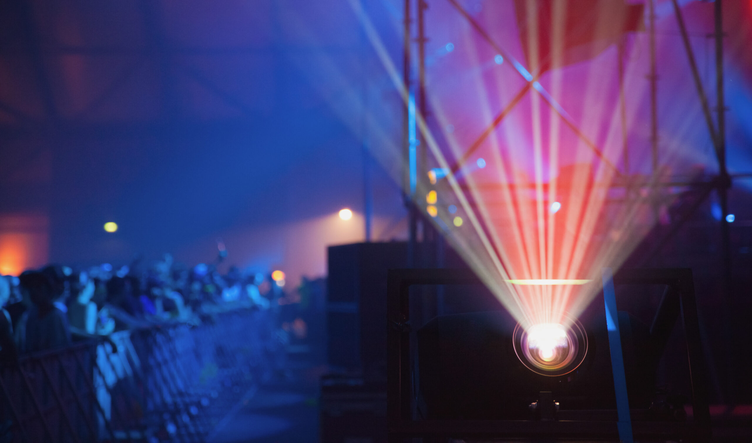 Colorful beams of bright laser light illuminating music venue during performance