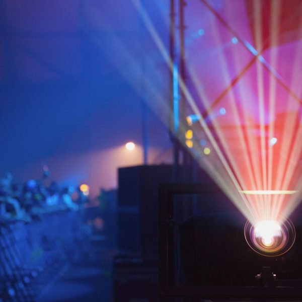 Colorful beams of bright laser light illuminating music venue during performance